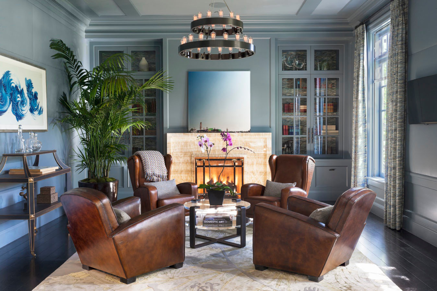 Adam Hunter Designed club room with four club chairs and blue walls.