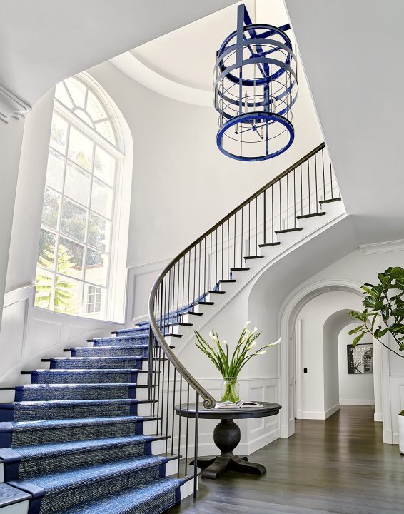 Adam Hunter designed entryway with a large blue light in staircase.