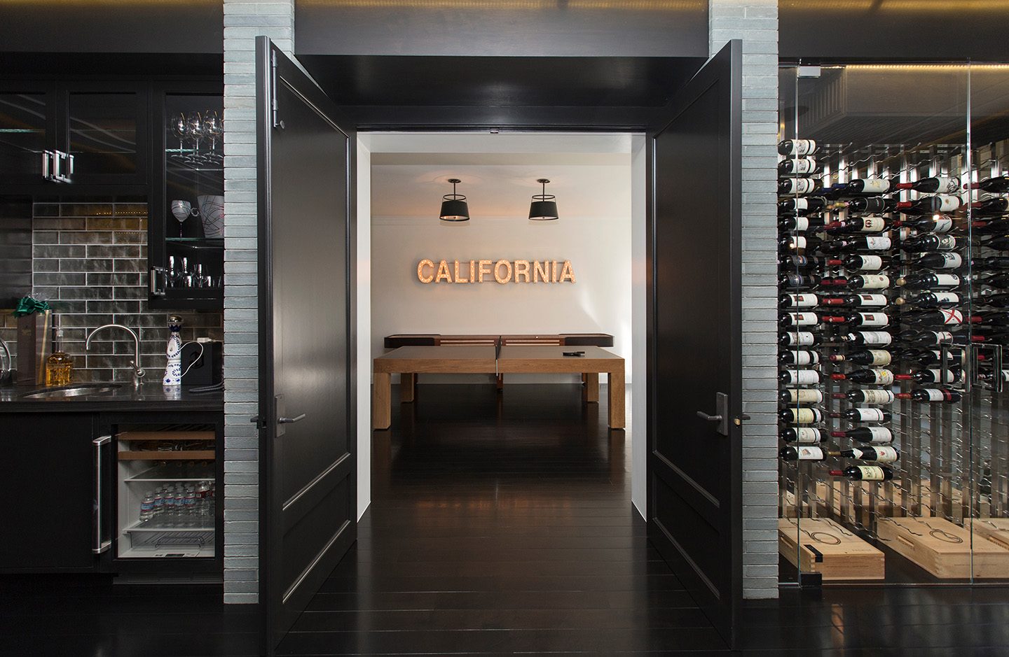 California interior designed by Adam Hunter that includes a wine room, bar and a ping pong table.