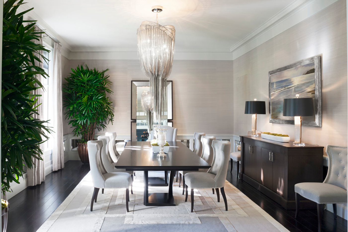 Adam Hunter designed this dining room with a large chandelier and accessories.