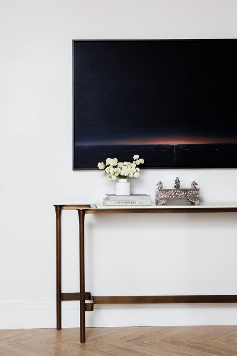 Adam Hunter designed entry space with console and photo.