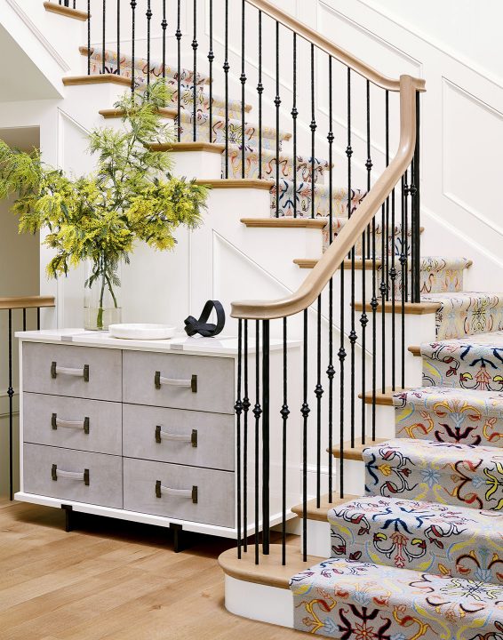 Adam Hunter designed foyer with a colorful carpet leading up the stairs.