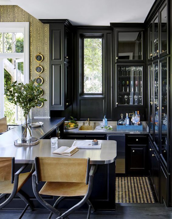 Adam Hunter designed bar with camel colored stools and matching wallpaper.