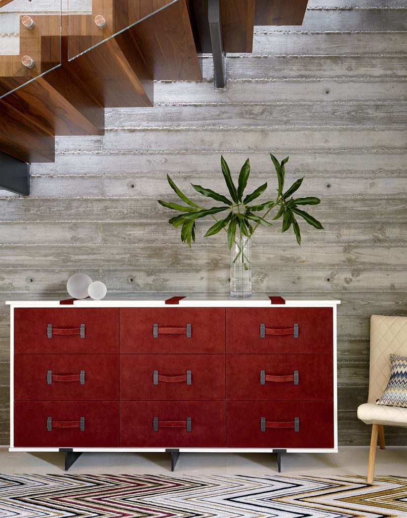 Adam Hunter designed console piece with red leather and palms for decoration.