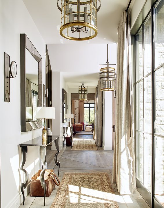 Adam hunter designed hallway with brass, marble and wood accents.
