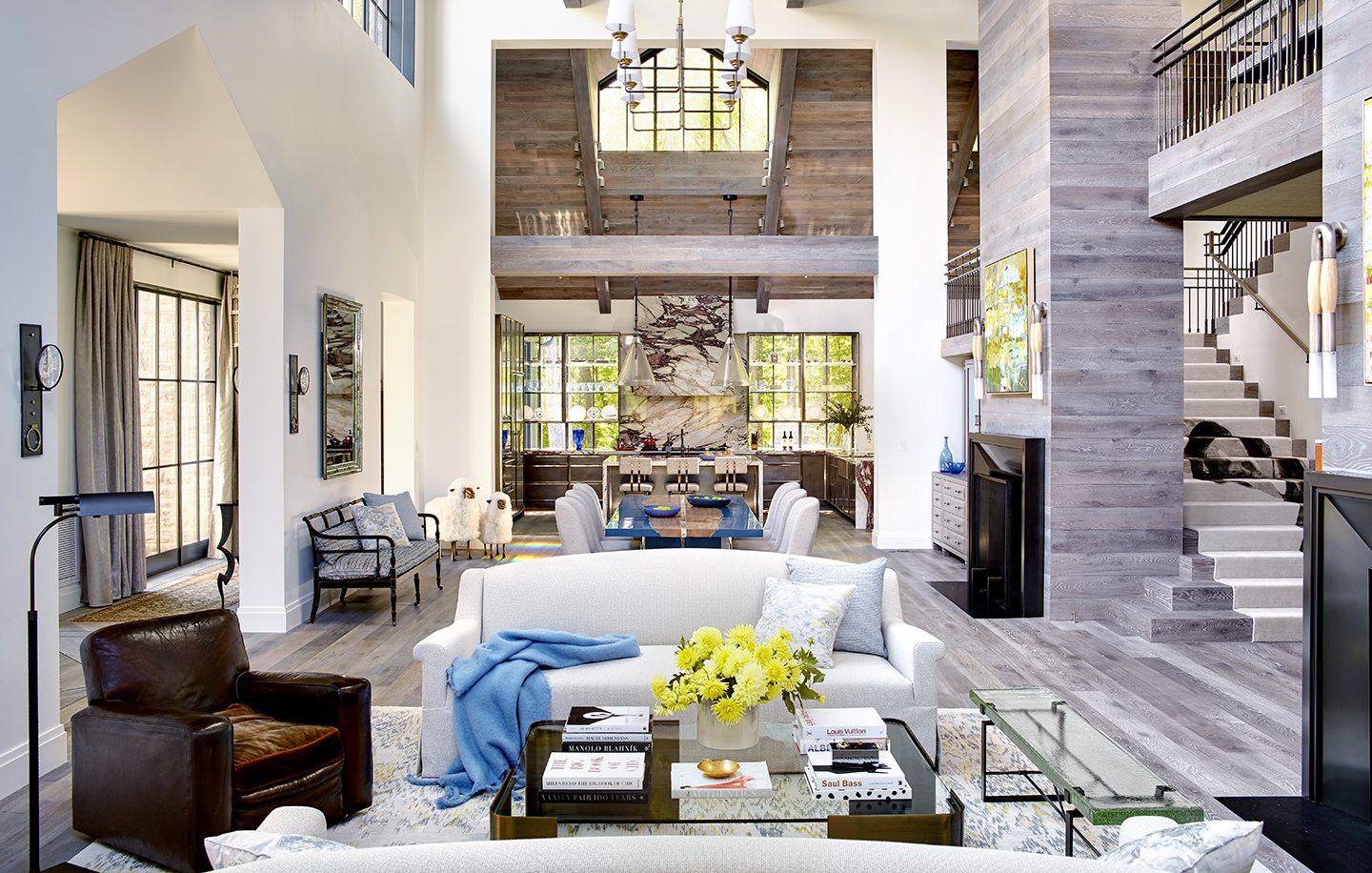 Adam hunter designed a great room with two big chandeliers.