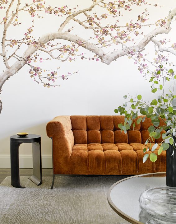 Adam Hunter designed guest suite with floral wallpaper and orange sofa.