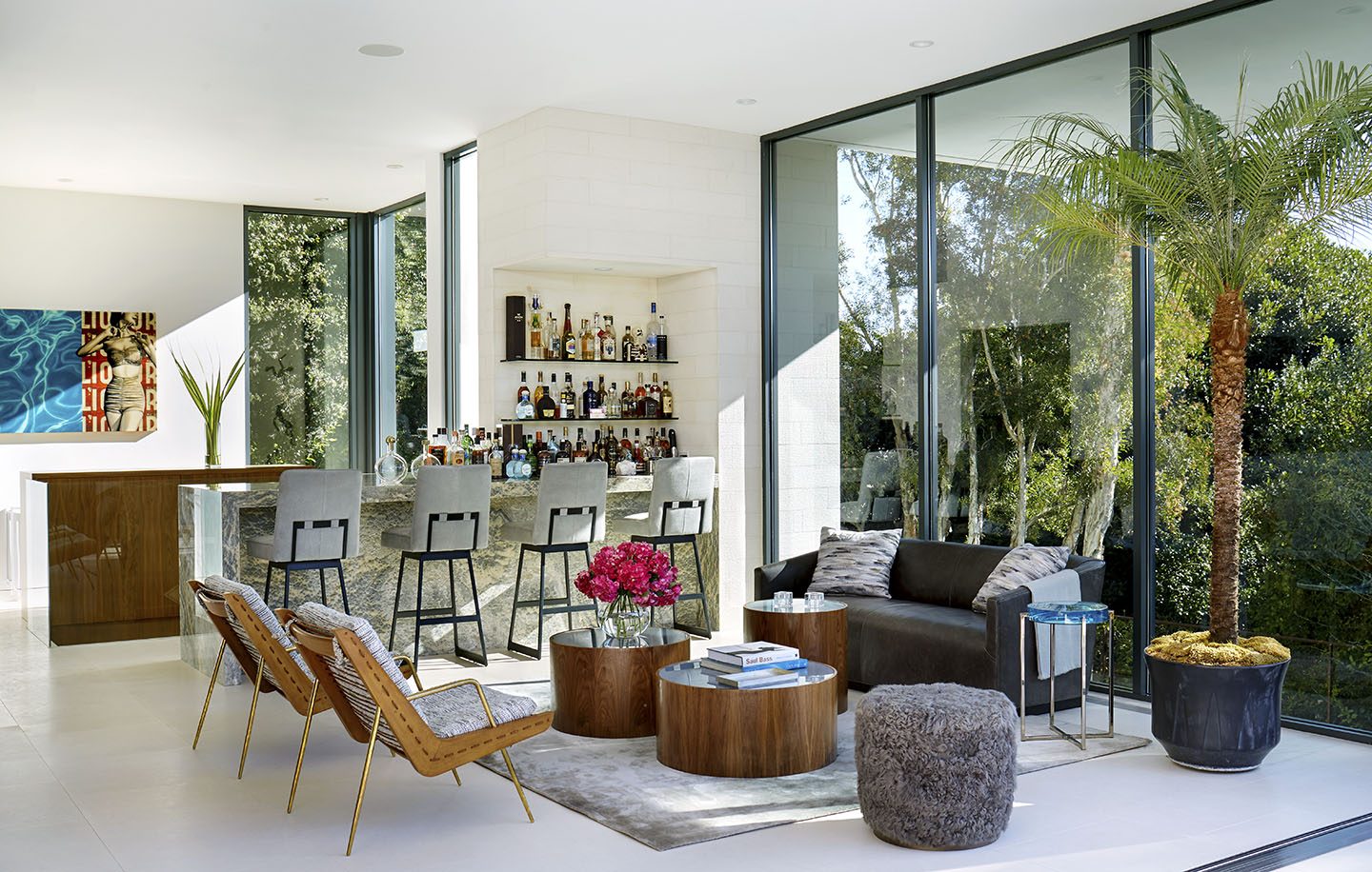 Adam Hunter designed living area with bar and sitting area with sofa and chairs.