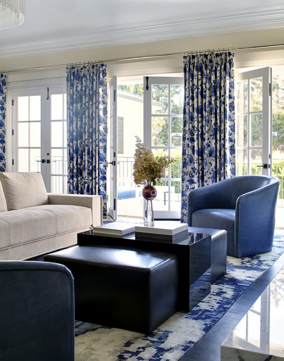 Adam Hunter designed master bedroom that includes a sofa, stationary drapery and a blue chair.