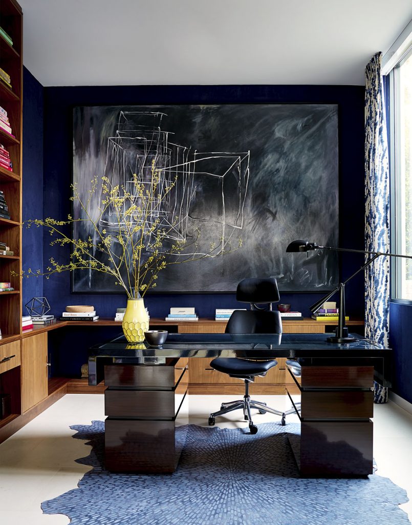 Adam Hunter designed study with navy blue wallpaper and a big desk.